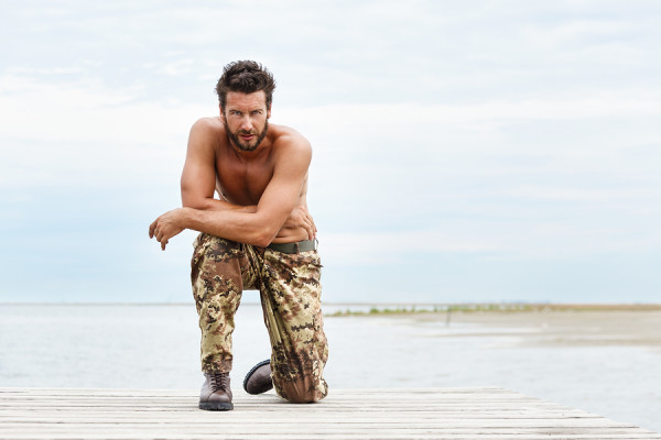 Portrait Of A Handsome Muscular Man In Camouflage Trousers